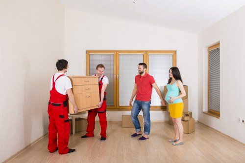 Professional movers handling household items in Harlow